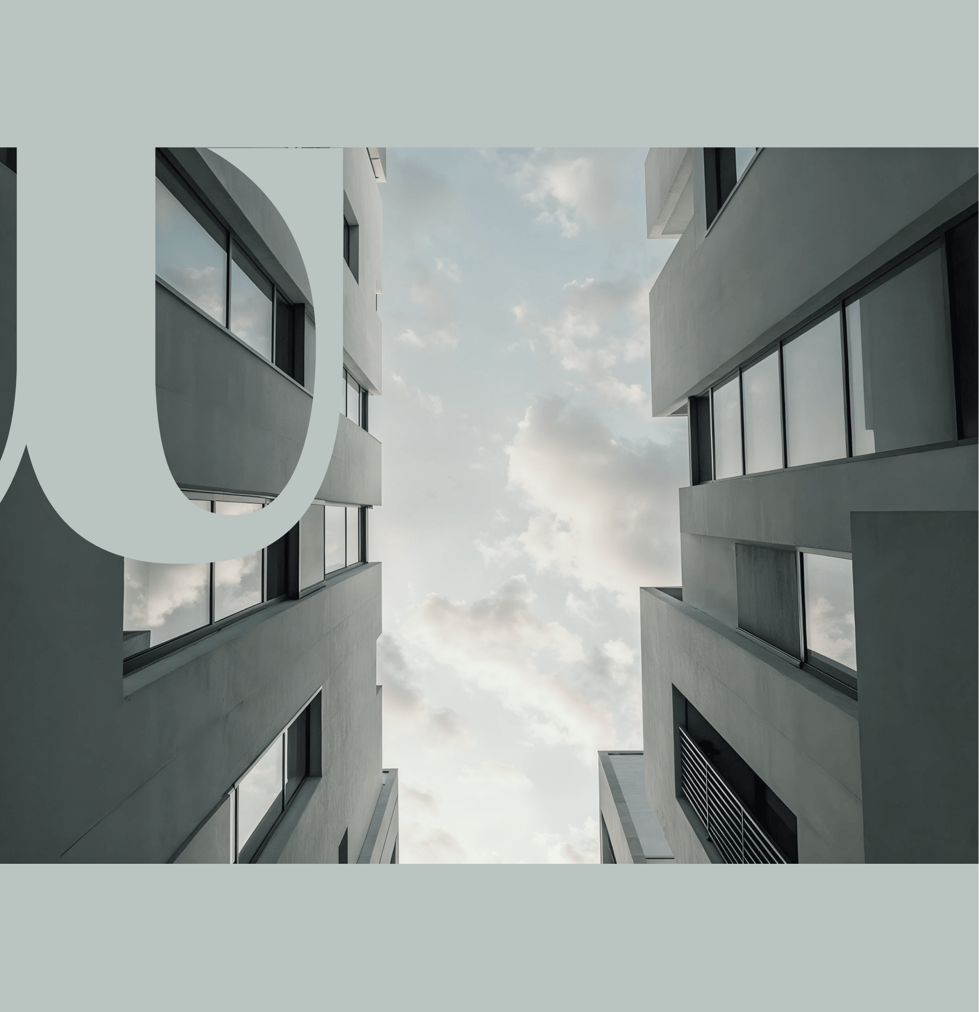 A modern apartment tower at twilight with lit windows