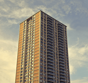 A tall residential high-rise against a golden sky