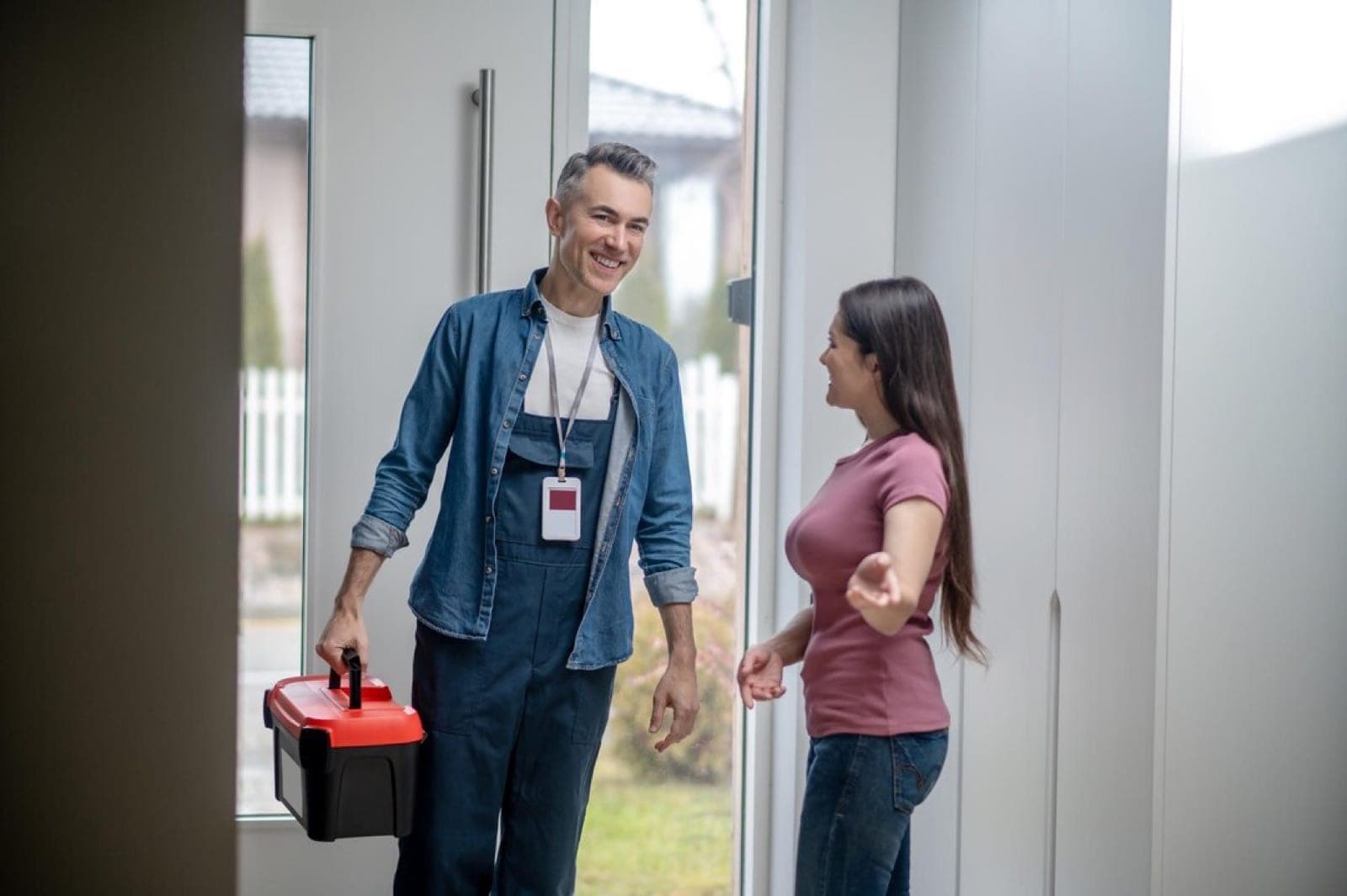 A third-party service technician arriving at a property with a tool box