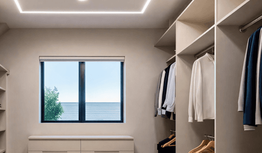 A walk-in closet with an ocean view, repurposed from a laundry room