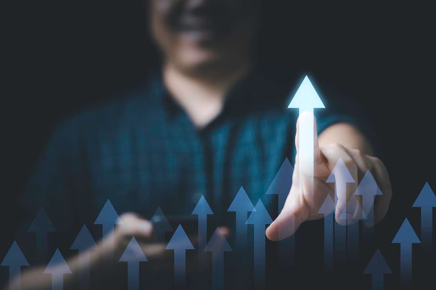 A hand tracing a rising arrow across a chart