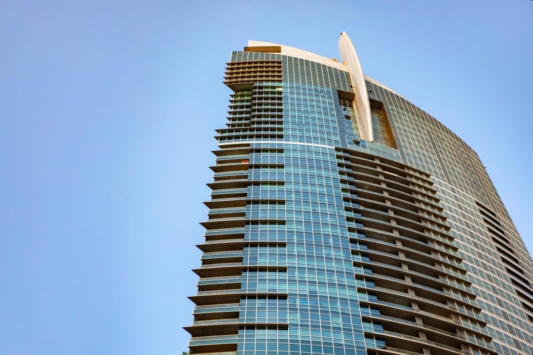 A modern residential high-rise seen from below