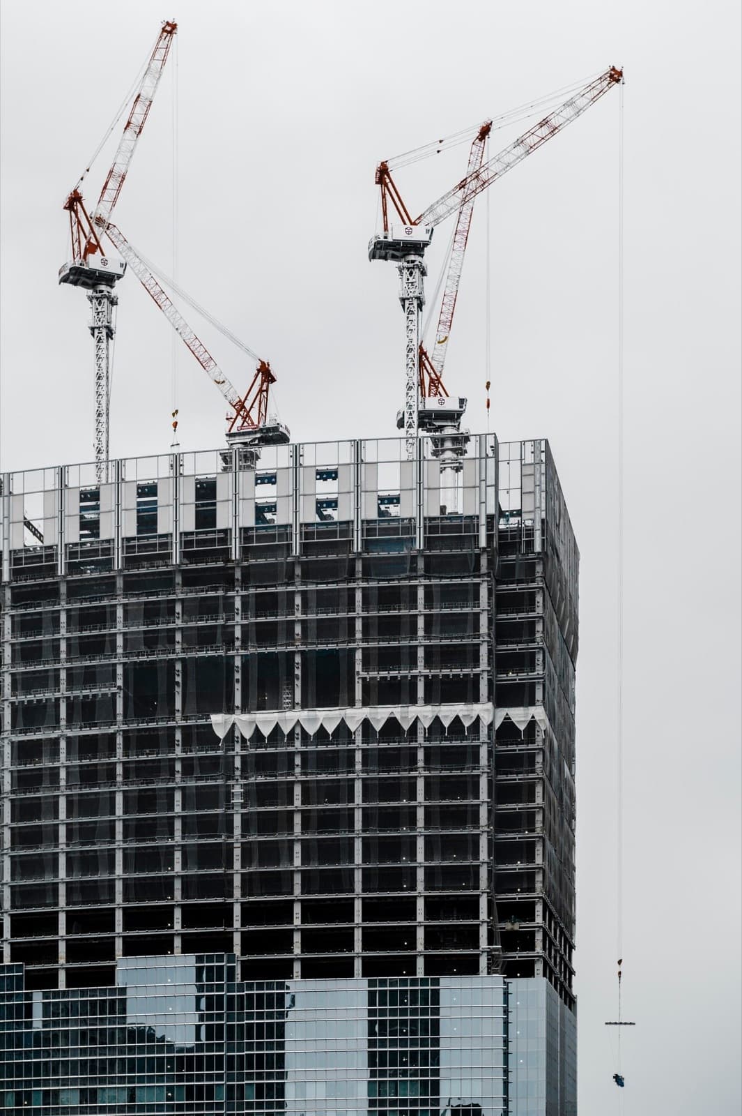 Tower cranes over a high-rise building under construction